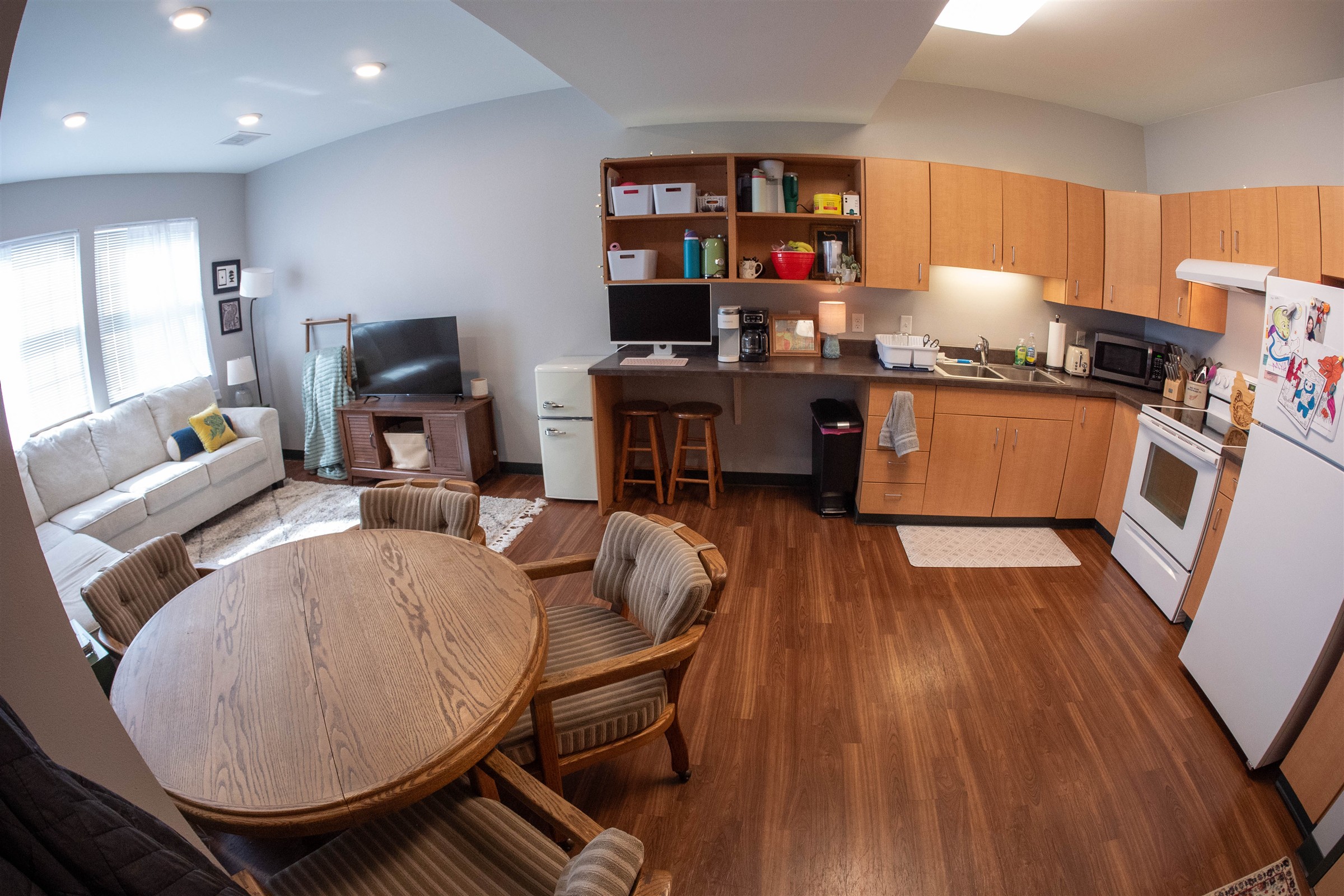 Interior of Richie Hall, kitchen with dining table next to living room